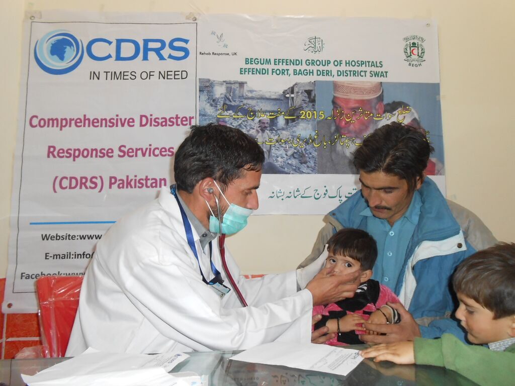 Doctor examining a child at a CDRS medical camp