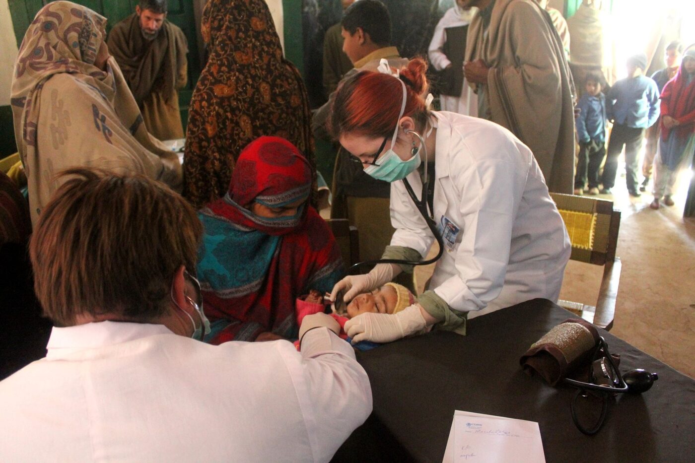 Clinicians treating patients at a field camp