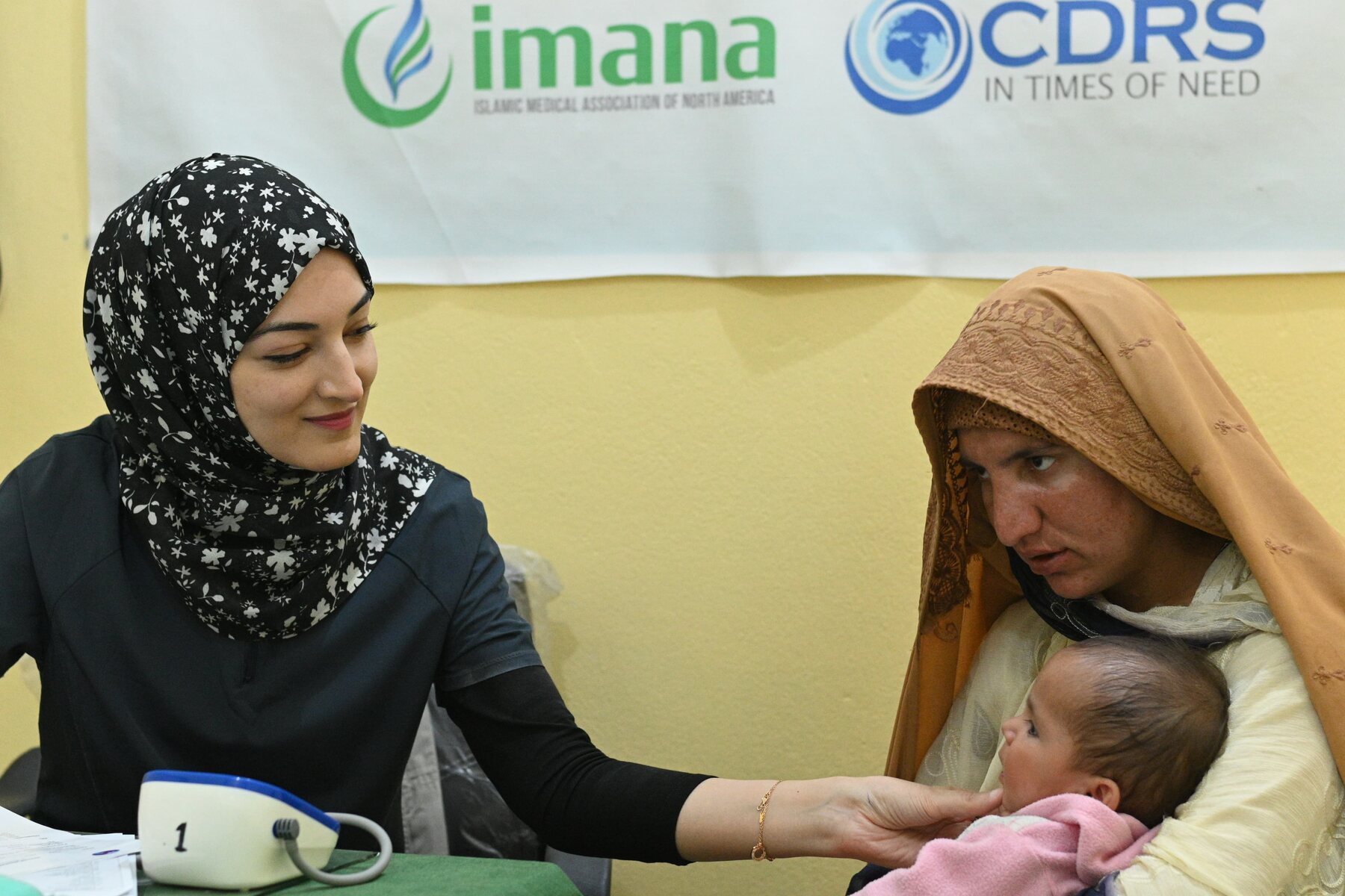 Consultation in progress — clinician with mother and child, MCHC Swat